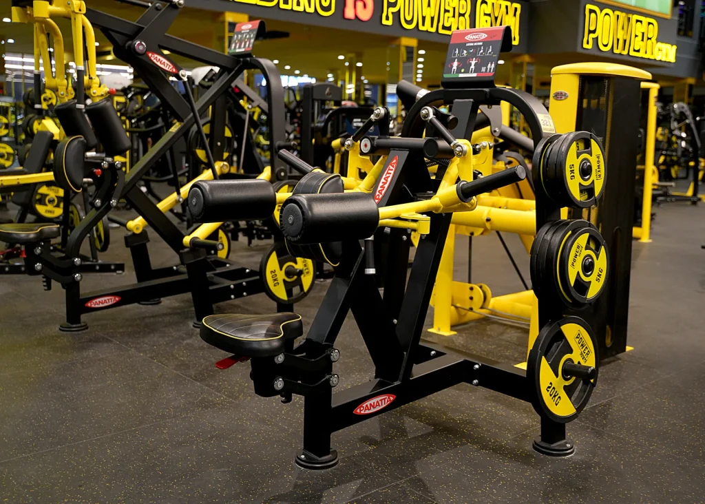 Panatta lateral deltoid machine in yellow and black with Power Gym plates at Power Gym Al Ahsa