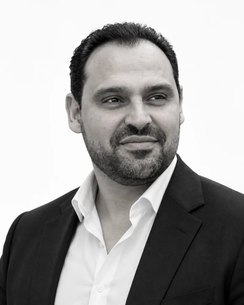 Black and white portrait of Assem Ashour, Chairman of the Board of Profit Sports Solutions